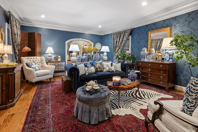 living room featuring hardwood / wood-style flooring and crown molding