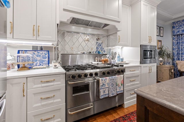 kitchen featuring dark hardwood / wood-style flooring, custom exhaust hood, white cabinets, ornamental molding, and stainless steel appliances