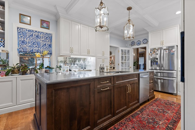 kitchen with pendant lighting, dark brown cabinetry, a center island, stainless steel appliances, and coffered ceiling