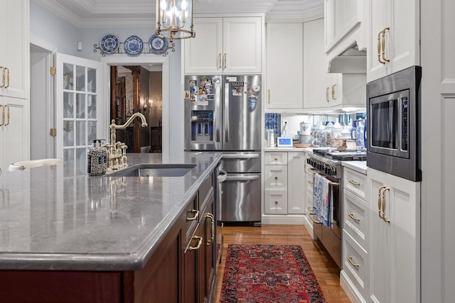 kitchen with white cabinetry, sink, stainless steel appliances, light stone counters, and dark hardwood / wood-style floors