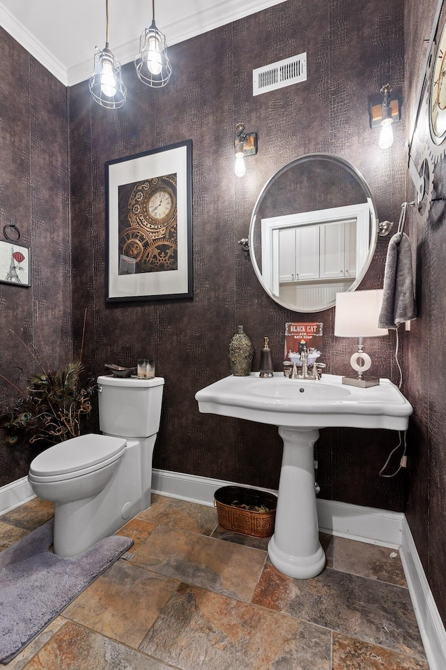 bathroom featuring toilet and ornamental molding