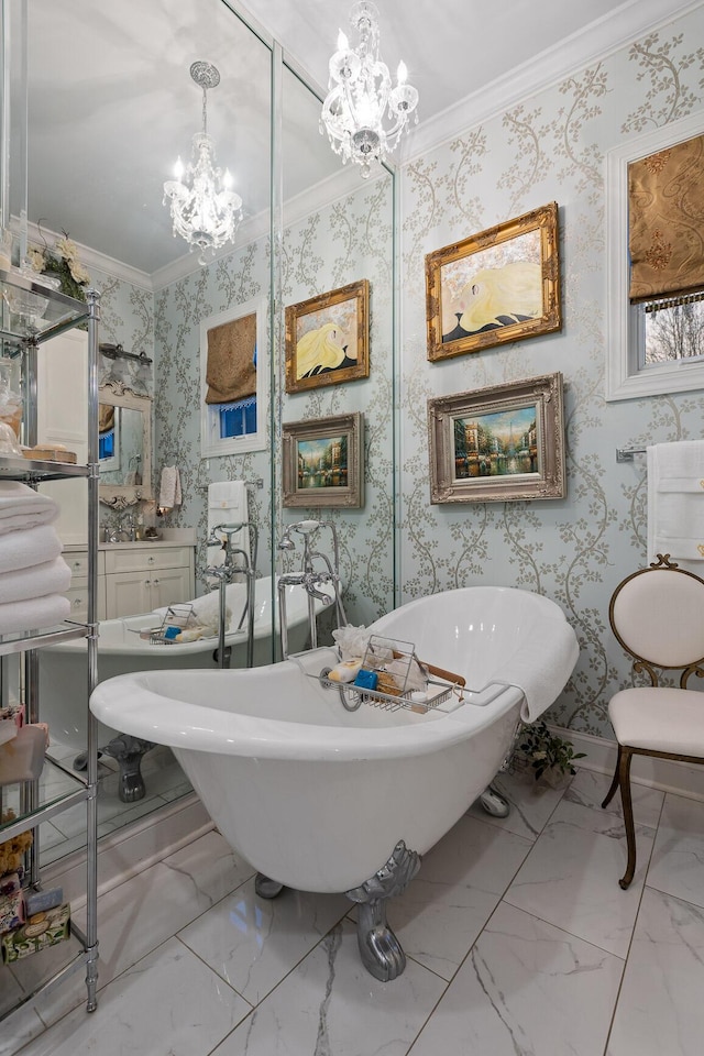 bathroom featuring a notable chandelier, a washtub, and ornamental molding