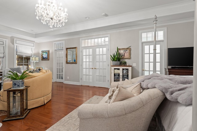 living room with crown molding, hardwood / wood-style flooring, a chandelier, french doors, and wine cooler