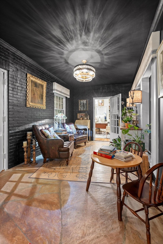 sitting room with brick wall and an inviting chandelier