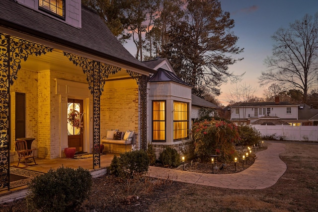 view of exterior entry at dusk