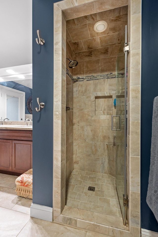 bathroom with an enclosed shower, tile patterned floors, and vanity