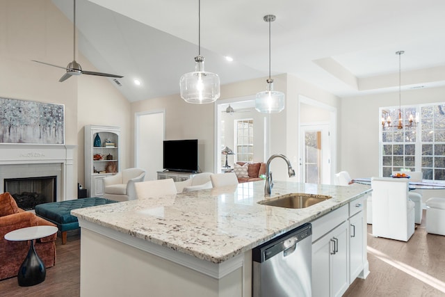 kitchen featuring sink, white cabinetry, dishwasher, and a kitchen island with sink