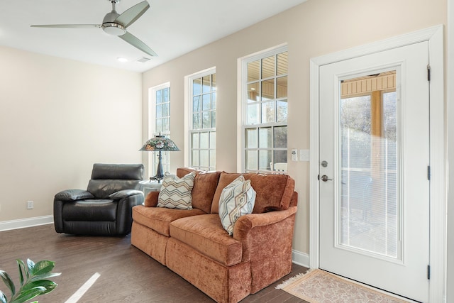 living room with dark wood-type flooring, a healthy amount of sunlight, and ceiling fan