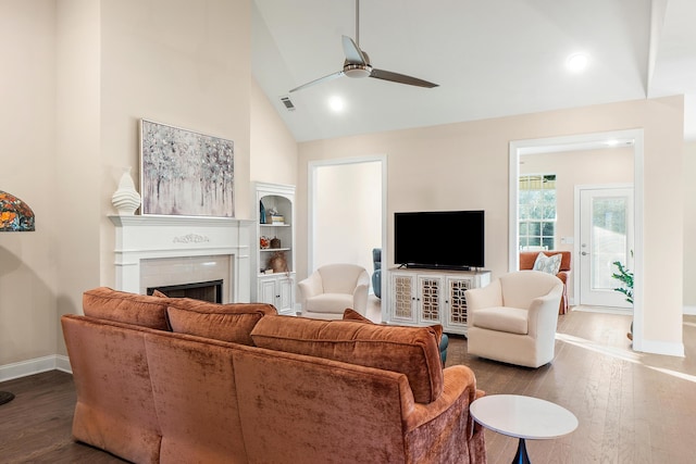 living room featuring high vaulted ceiling, built in shelves, dark hardwood / wood-style floors, and ceiling fan