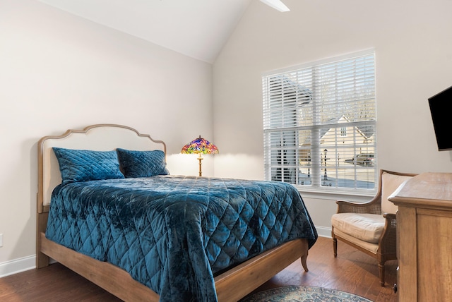 bedroom with multiple windows, dark hardwood / wood-style floors, and vaulted ceiling