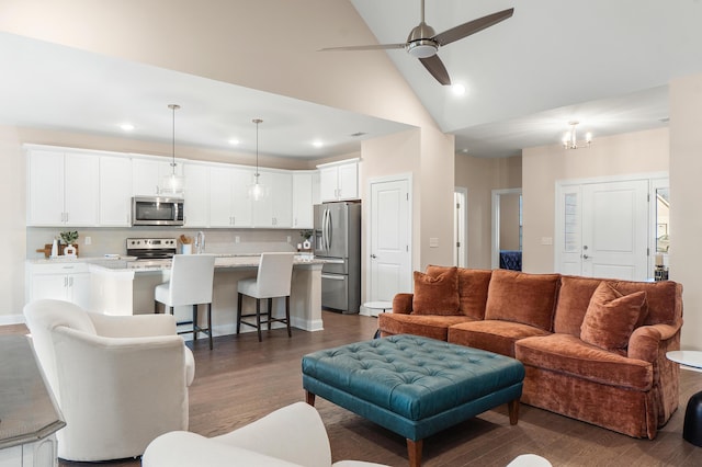 living room with high vaulted ceiling, dark hardwood / wood-style flooring, and ceiling fan