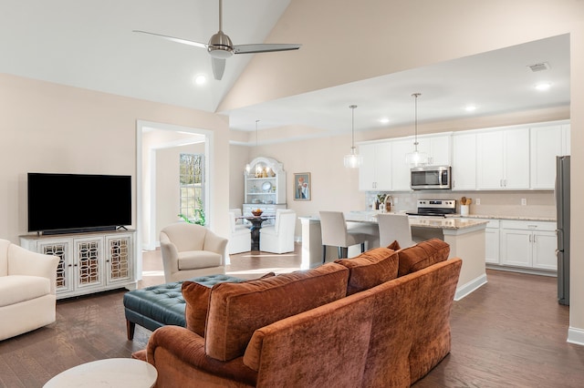 living room with dark hardwood / wood-style floors, vaulted ceiling, and ceiling fan