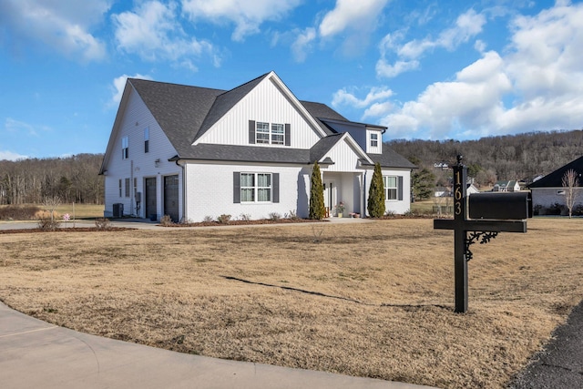 modern inspired farmhouse featuring a garage and a front yard