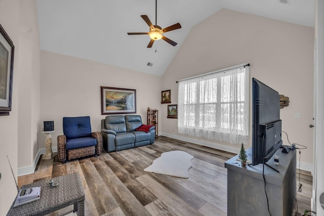 living room with wood-type flooring, high vaulted ceiling, and ceiling fan