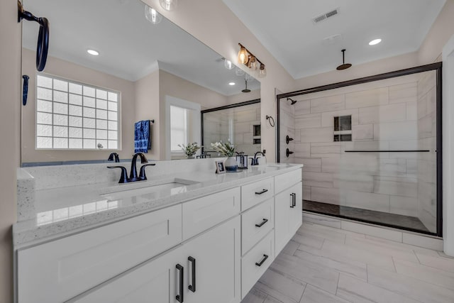 bathroom with vanity and a shower with shower door