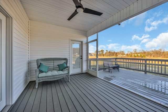 wooden deck featuring ceiling fan