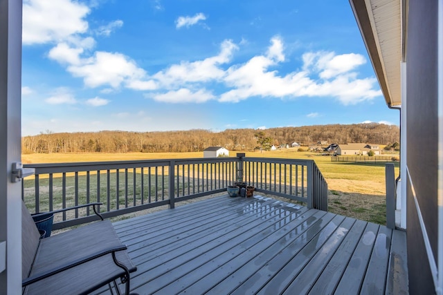 wooden deck featuring a lawn