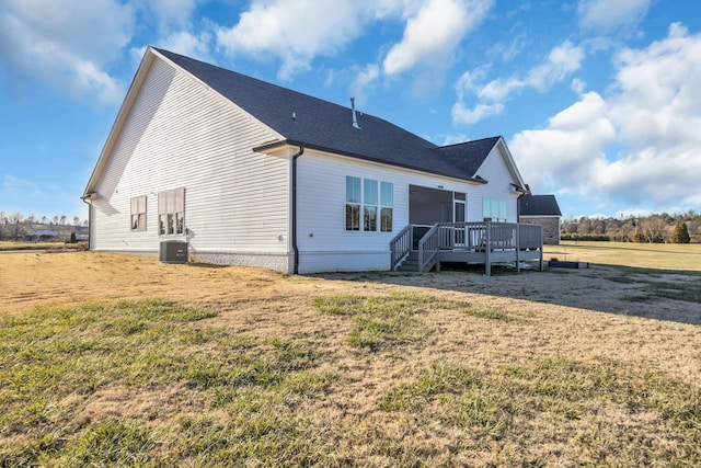 back of property featuring central AC unit, a yard, and a deck