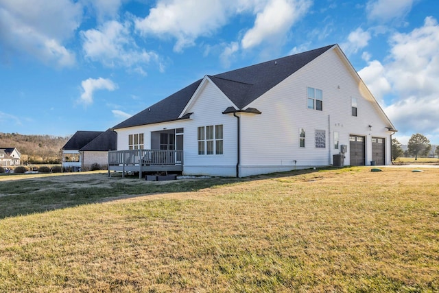 back of property with cooling unit, a deck, and a lawn