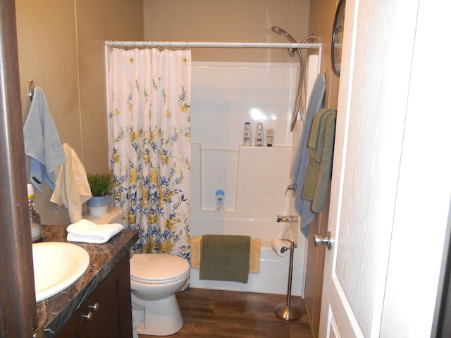 full bathroom featuring vanity, hardwood / wood-style floors, toilet, and shower / bathtub combination with curtain