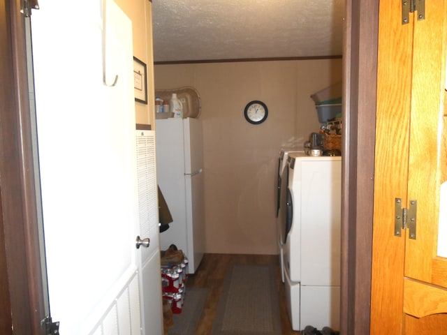 washroom featuring washer and dryer and a textured ceiling