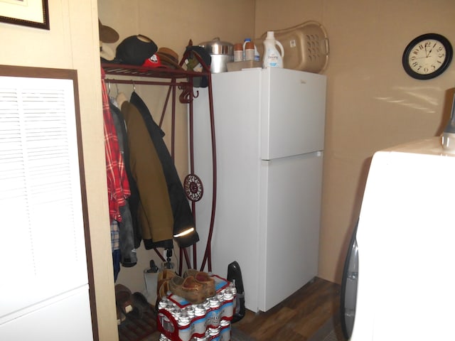 washroom with washer / clothes dryer and dark hardwood / wood-style floors