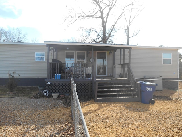 back of property with covered porch