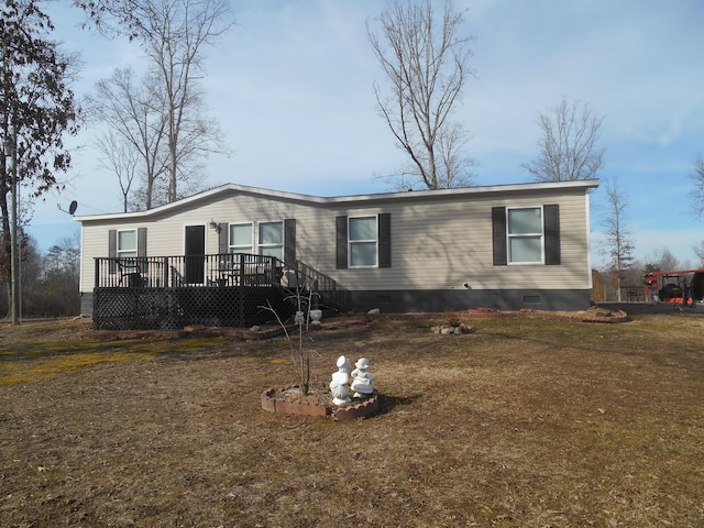 view of front of property with a front yard and a deck