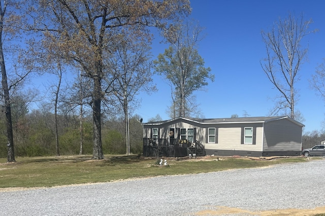 manufactured / mobile home featuring crawl space, a front lawn, and a deck