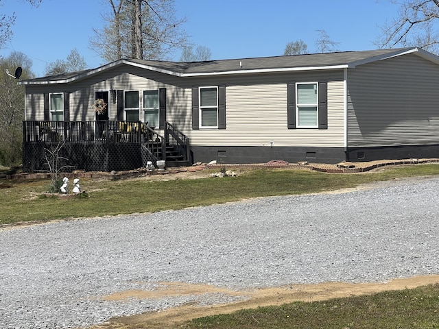 view of front of property featuring a front lawn, crawl space, and a wooden deck