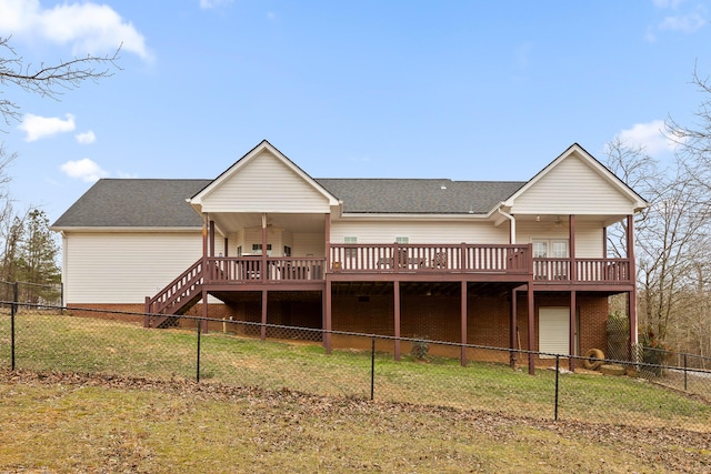 back of house with a yard, a deck, and ceiling fan