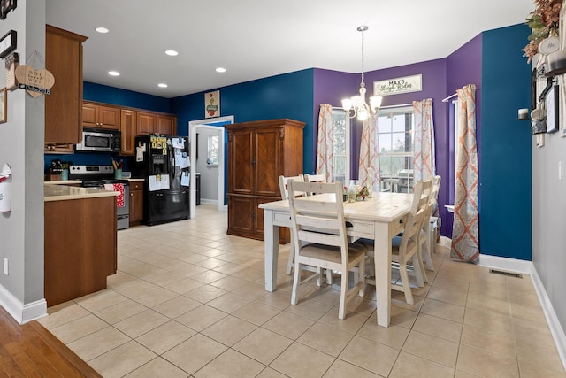 dining area with an inviting chandelier and light tile patterned flooring