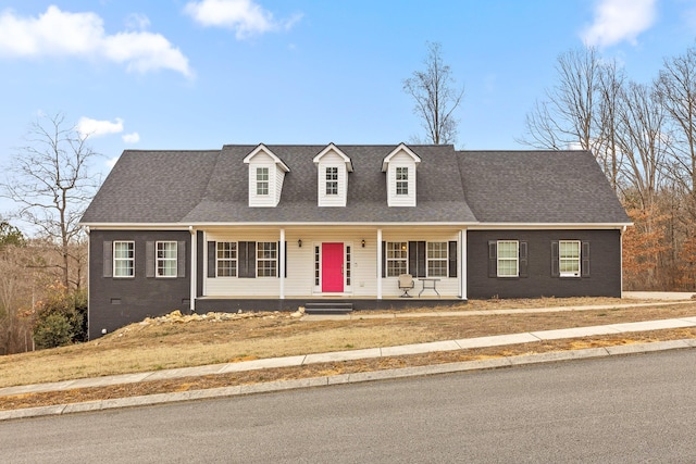 new england style home with a porch