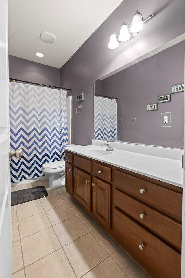 bathroom with tile patterned floors, vanity, and toilet