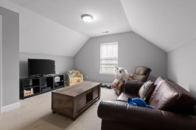 carpeted living room with vaulted ceiling