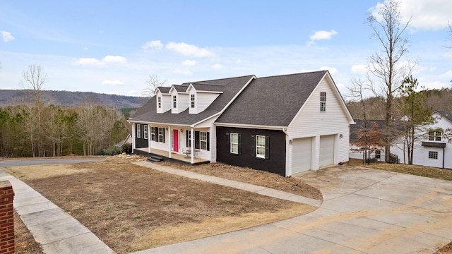 cape cod-style house featuring a garage and a porch