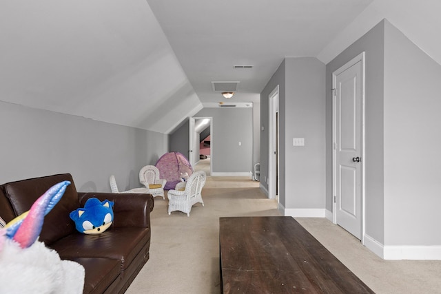 interior space with light carpet and lofted ceiling