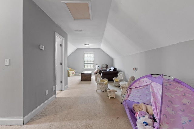 unfurnished bedroom featuring light colored carpet and vaulted ceiling