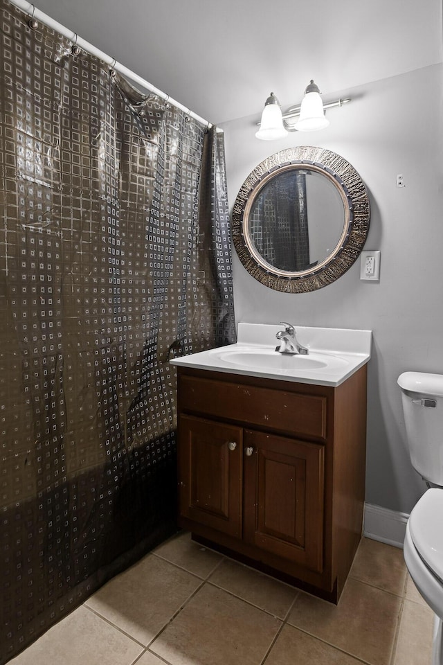 bathroom featuring toilet, vanity, and tile patterned flooring