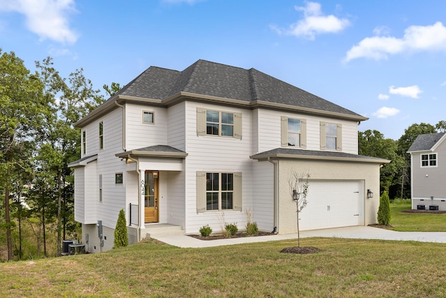 view of front of house featuring a garage, central AC unit, and a front yard