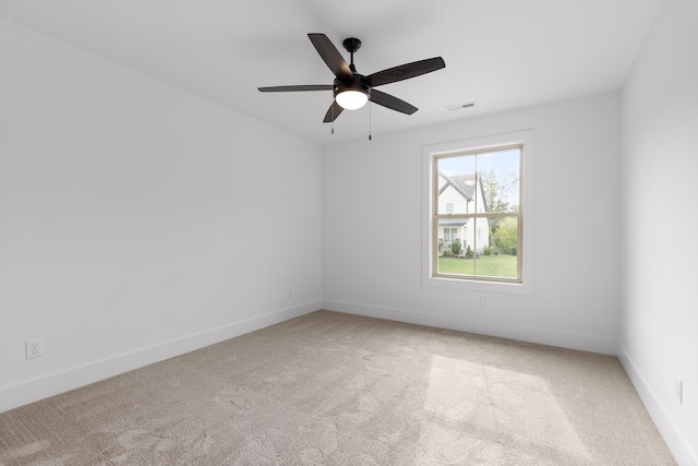 carpeted spare room with ceiling fan