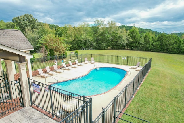 view of pool with a yard and a patio