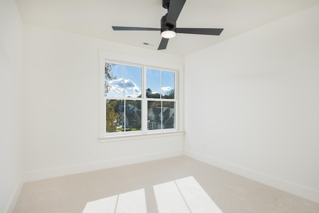 carpeted spare room featuring ceiling fan