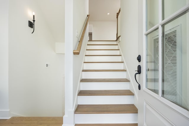 stairs featuring wood-type flooring