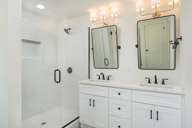 bathroom featuring vanity and a shower with door