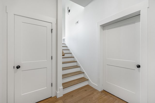 stairs featuring hardwood / wood-style floors