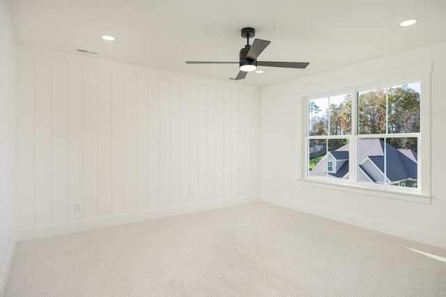 empty room featuring carpet floors and ceiling fan