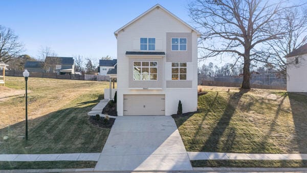 view of front facade with a garage and a front lawn