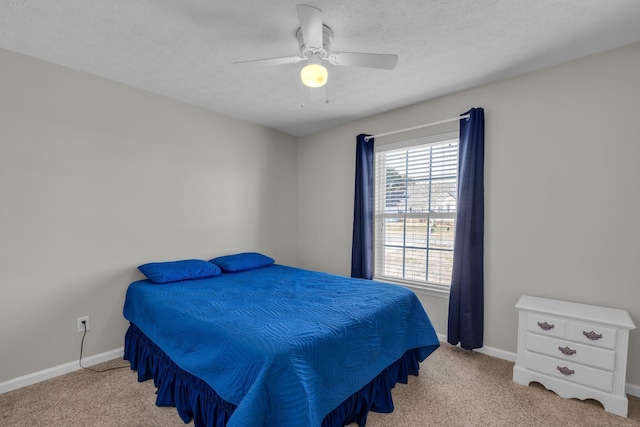 carpeted bedroom featuring a textured ceiling and ceiling fan