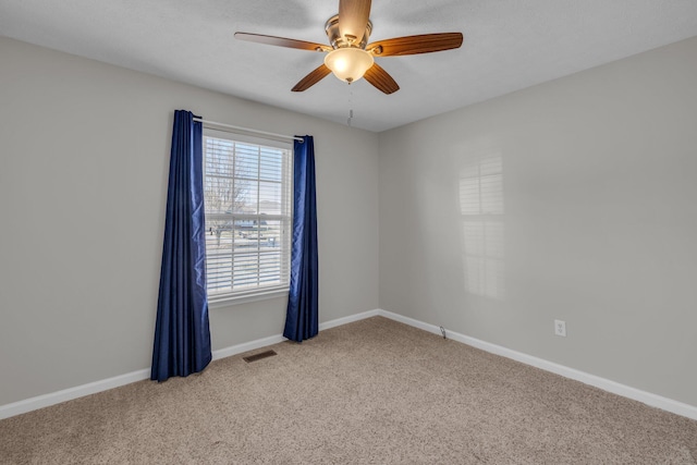 unfurnished room with ceiling fan and light colored carpet